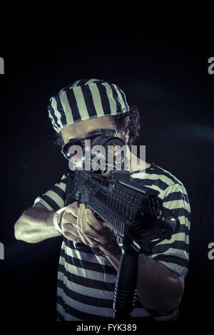 rebel, prisoner in a prison with a machine gun Stock Photo