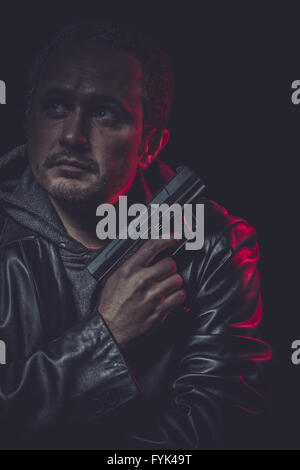 Agent, Assassin, man with black coat and gun Stock Photo - Alamy
