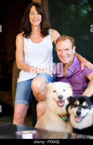 Senior man and woman portrait with their 2 dogs Stock Photo