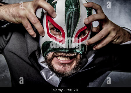 Shouting, angry businessman  with Mexican wrestler mask Stock Photo