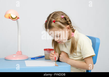 Six year old girl keen on drawing Stock Photo
