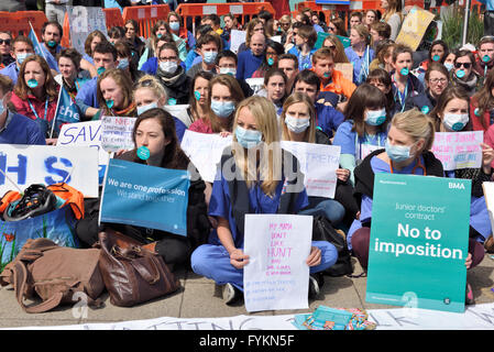 Bristol junior doctors sitting down in silent protest in front of the Bristol Royal Infirmary against the imposition of new contract terms set by Jeremy Hunt. Over 250  junior doctors demonstrating against the terms which they think will put patients at risk due to possible long hours on shift duty. “Credit: CHARLES STIRLING/Alamy Live News” Stock Photo