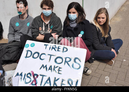 Bristol junior doctors sitting down in silent protest in front of the Bristol Royal Infirmary against the imposition of new contract terms set by Jeremy Hunt. Over 250  junior doctors demonstrating against the terms which they think will put patients at risk due to possible long hours on shift duty. “Credit: CHARLES STIRLING/Alamy Live News” Stock Photo