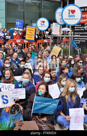 Bristol junior doctors sitting down in silent protest in front of the Bristol Royal Infirmary against the imposition of new contract terms set by Jeremy Hunt. Over 250  junior doctors demonstrating against the terms which they think will put patients at risk due to possible long hours on shift duty. “Credit: CHARLES STIRLING/Alamy Live News” Stock Photo