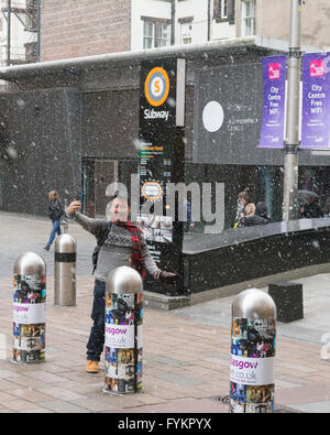 Glasgow, Scotland, UK. 27th Apr, 2016. UK weather - taking selfies in flurries of snow and hail in Glasgow on an otherwise bright sunny day in Glasgow Credit:  Kay Roxby/Alamy Live News Stock Photo