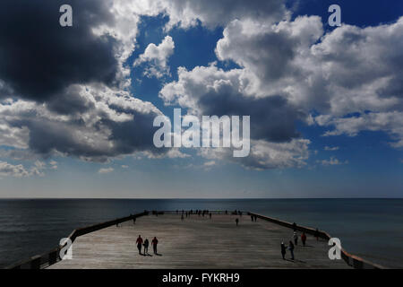 Hastings, UK. 27th Apr, 2016. People walk to the end of the newly reopened Hastings Pier in Hastings, East Sussex, UK Wednesday April 27, 2016. The pier opened today after a £14million refurbishment following a fire in October 2010, the pier had been closed to the public since 2008. Credit:  Luke MacGregor/Alamy Live News Stock Photo