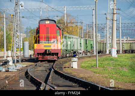 Red locomotive of a long freight cargo train loaded with containers ...