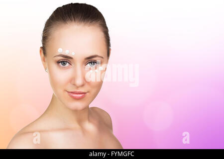 Girl with cream dots on face Stock Photo