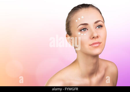 Girl with cream dots on face Stock Photo