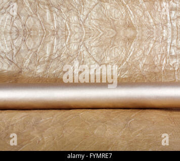 Rolls of golden wrapping paper for gifts on abstract background. Stock Photo