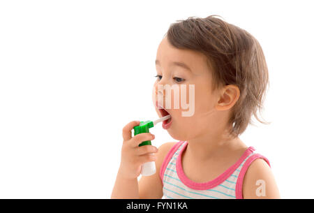 Little sick girl used medical spray for breath Stock Photo