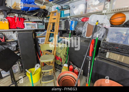 Storage corner in cluttered suburban garage. Stock Photo