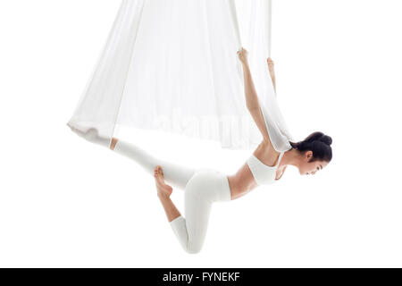 Young woman practicing aerial yoga Stock Photo