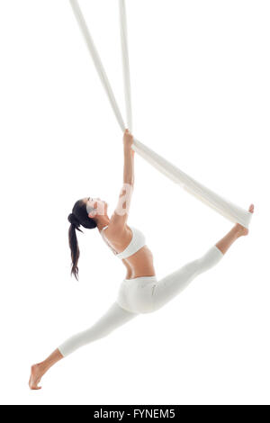 Young woman practicing aerial yoga Stock Photo