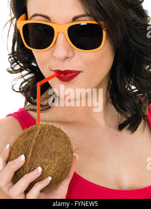 Attractive Healthy Young Woman Drinking From A Fresh Coconut Isolated Against a White Background Stock Photo