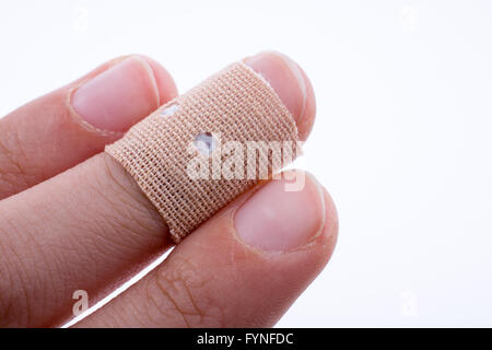 finger in white bandage on a white background Stock Photo