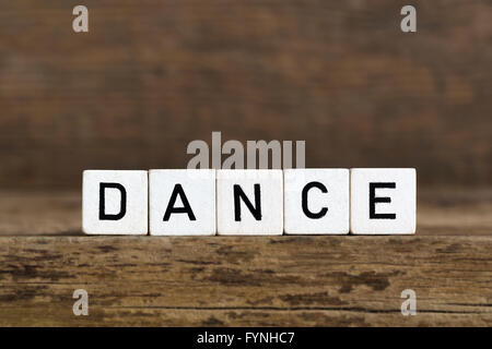 The word dance written in cubes on wooden background Stock Photo