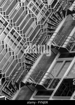 Mono image of external winding stairs and exterior architectural details on office building in Barcelona, Spain Stock Photo