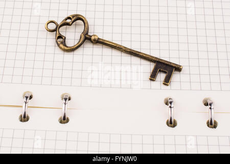 Retro key on a spiral notebook Stock Photo