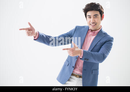Fashionable young man pointing Stock Photo