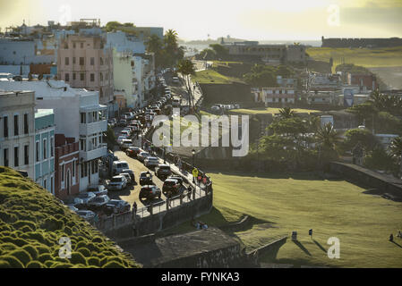 A view of Calle Norzagaray in Old San Juan, with colorful homes, leading to the ocean and El Morro Stock Photo