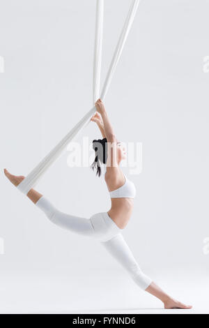 Young woman practicing aerial yoga Stock Photo