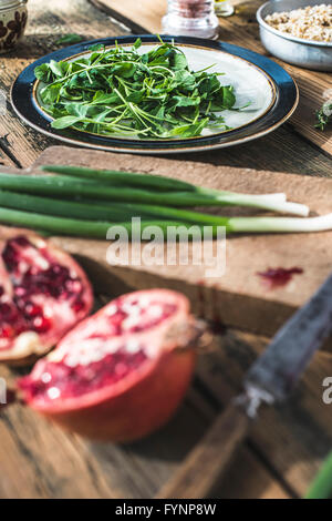 Green salad with pomegranate, manna croup, onion. Pomegranate dressing. Stock Photo