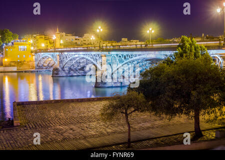 Seville is divided in two by the river Guadalquivir, and its most famous bridge is the Triana bridge, connecting the historic ce Stock Photo