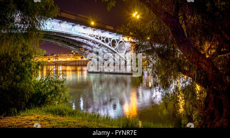 Seville is divided in two by the river Guadalquivir, and its most famous bridge is the Triana bridge, connecting the historic ce Stock Photo