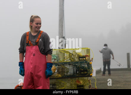 A Lobster Fisherwoman hauling traps Stock Photo