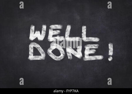 well done - white text on black chalkboard Stock Photo