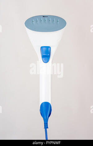Hand household steamer on a light background Stock Photo