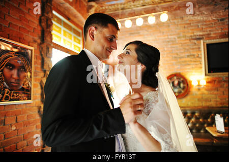 Smiling cute bride looking at her groom Stock Photo