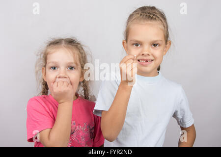 Six year old girl showing her teeth, four-year girl afraid of toothache Stock Photo