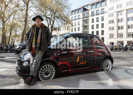 London, UK. 27 April 2016. Pictured: British-Israeli designer Ron Arad poses with his personal Fiat 500, with a 1:1 scale drawing of the 1957 model Cinquecento. The car will be auctioned off. The world's leading designers and artists come together for Time for Design, an auction in aid of the new Design Museum in London. Amongst the star lots are Bono's guitar and a special edition iPad Pro designed by Jony Ive of Apple. The benefit auction will be held at Phillips in London on 28 April 2016. All proceeds will go towards realising the Design Museum's ambition of creating the world's leading mu Stock Photo