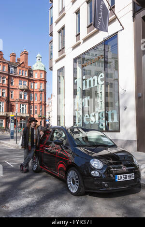 London, UK. 27 April 2016. Pictured: British-Israeli designer Ron Arad poses with his personal Fiat 500, with a 1:1 scale drawing of the 1957 model Cinquecento. The car will be auctioned off. The world's leading designers and artists come together for Time for Design, an auction in aid of the new Design Museum in London. Amongst the star lots are Bono's guitar and a special edition iPad Pro designed by Jony Ive of Apple. The benefit auction will be held at Phillips in London on 28 April 2016. All proceeds will go towards realising the Design Museum's ambition of creating the world's leading mu Stock Photo