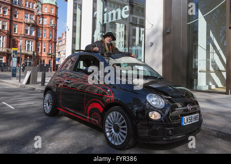 London, UK. 27 April 2016. Pictured: British-Israeli designer Ron Arad poses with his personal Fiat 500, with a 1:1 scale drawing of the 1957 model Cinquecento. The car will be auctioned off. The world's leading designers and artists come together for Time for Design, an auction in aid of the new Design Museum in London. Amongst the star lots are Bono's guitar and a special edition iPad Pro designed by Jony Ive of Apple. The benefit auction will be held at Phillips in London on 28 April 2016. All proceeds will go towards realising the Design Museum's ambition of creating the world's leading mu Stock Photo