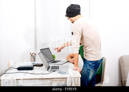 Two co-workers discussing something in the office Stock Photo