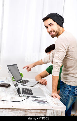 Two co-workers discussing something in the office Stock Photo