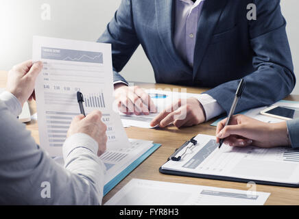 Financial service professional team at work, hands close with business reports and paperwork Stock Photo