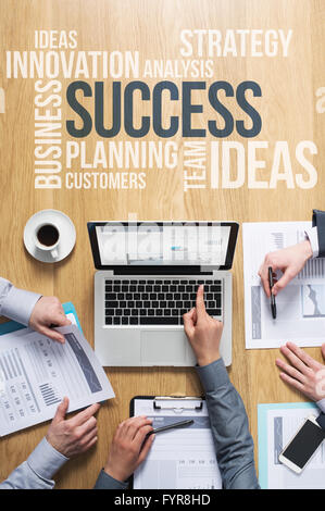 Business team hands at work with financial reports and a laptop, business and marketing text concepts on top Stock Photo