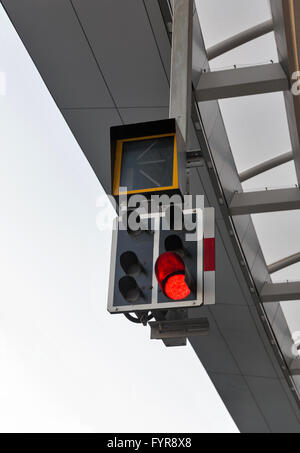 modern railway semaphore with red light on passenger station Stock Photo