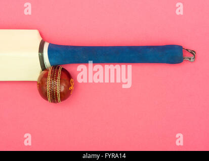 Cricket bat and ball on pink background Stock Photo
