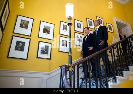 U.S President Barack Obama and British Prime Minister David Cameron walks down the staircase inside Number 10 Downing Street April 22, 2016 in London, United Kingdom. Stock Photo