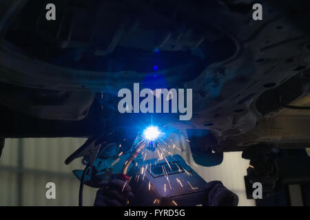 Welder working in protective mask Stock Photo