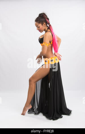 Young girl mulatto dancing in a long black dress candid Stock Photo