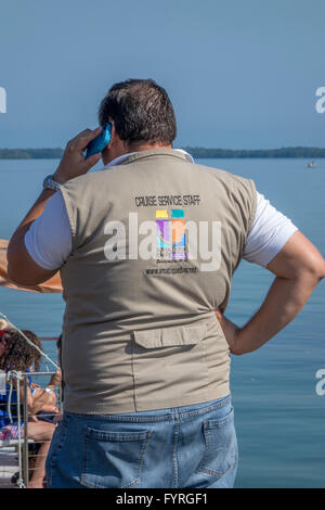 A Man Selling Tours To Amatique Bay Resort For Cruise Ship Passengers On The Dockside In Santo Tomas De Castilla, Guatemala Stock Photo