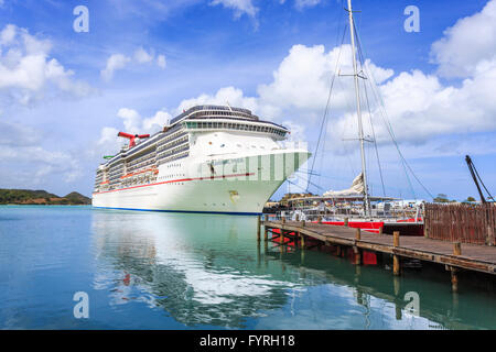 Cruise ship 'Carnival Pride' moored in capital city St John's Deep Water Harbour, Antigua and Barbuda on a bright sunny day Stock Photo