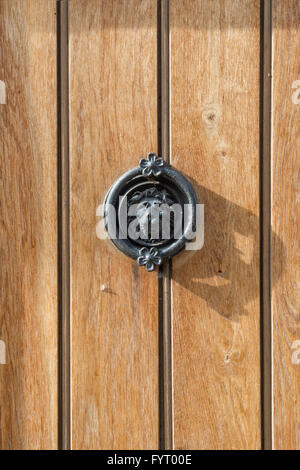 Lion head door knocker on a wooden front door. Cotswolds, UK Stock Photo