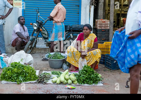 Indian lady trying to sell vegetables at the side of the Chennai Road, Villupuram, Tamil Nadu, India Stock Photo